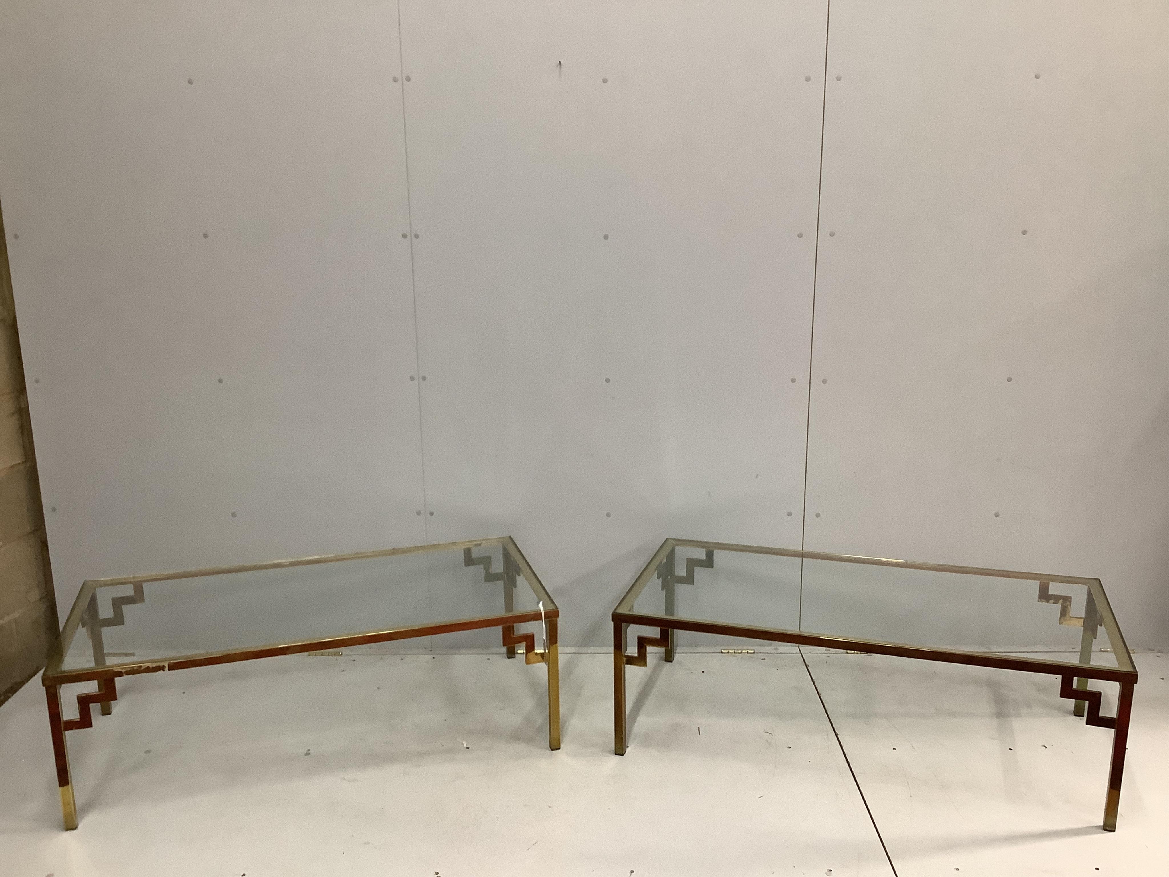 A pair of mid century brass and clear glass top coffee tables, width 122cm, depth 62cm, height 41cm. Condition - fair